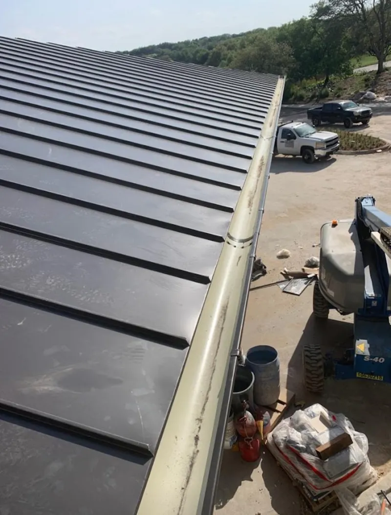 Standing seam panel and gutter detail on a metal roofing jobsite in Lincoln